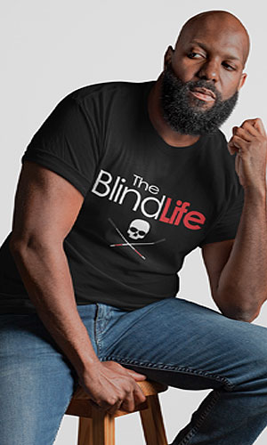 a man wearing a black t-shirt with the Blind Life logo