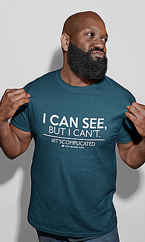 A man wearing a blue shirt with I can see But I can't #ItsComplicated -The Blind Life